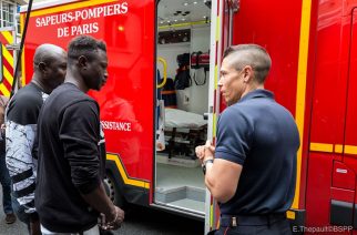 Mamoudou Gassama, second left, visits the Paris Fire Brigade headquarters and Champerret fire station in Paris on Tuesday. — AFP
