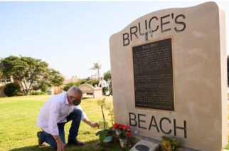 A commemorative monument at the beach is often adorned with tributes - and a wedding photo of the pioneering Bruces